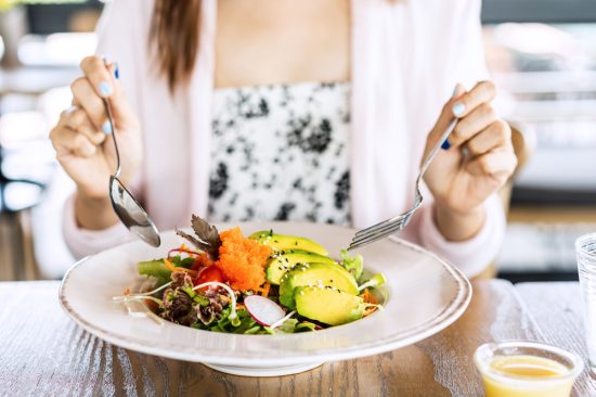 Young,Woman,Eating,Healthy,Salad,At,Restuarant,,Healthy,Lifestyle,,Diet